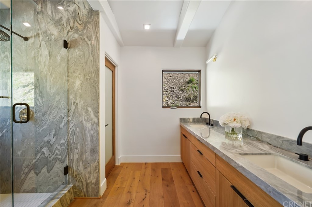 431 Nesmuth Road Glendale, CA 91202 - Photo 25 of 68 a spacious bathroom with a granite countertop sink a mirror and shower