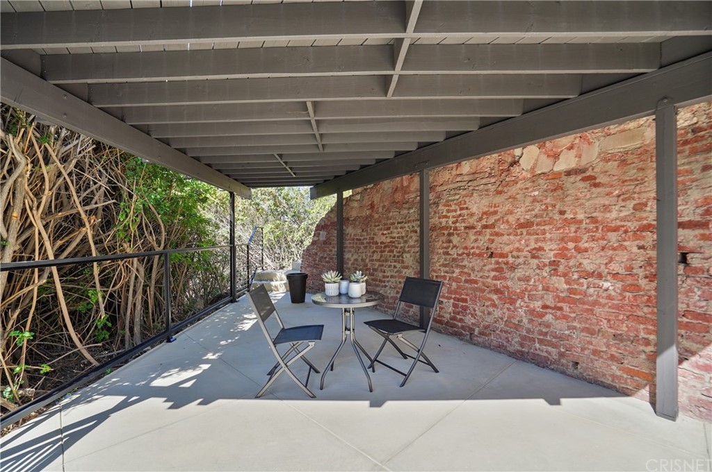 431 Nesmuth Road Glendale, CA 91202 - Photo 34 of 68 a view of a patio with table and chairs and wooden floor