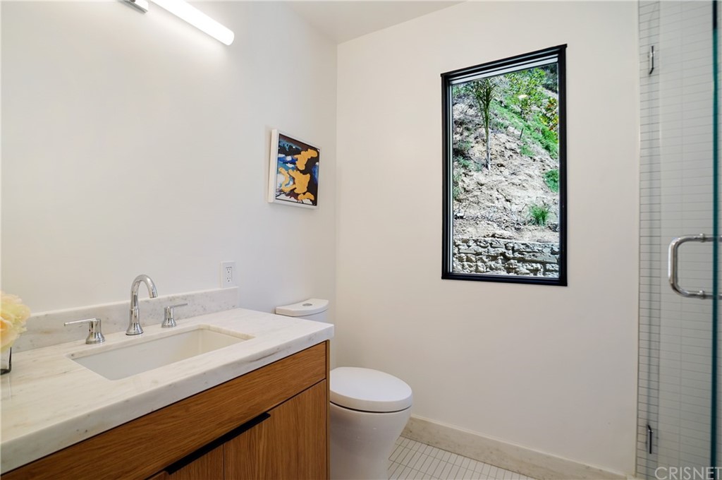 431 Nesmuth Road Glendale, CA 91202 - Photo 43 of 68 a bathroom with a sink mirror vanity and toilet