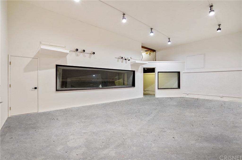 431 Nesmuth Road Glendale, CA 91202 - Photo 61 of 68 a view of an empty room with a fireplace and cabinet