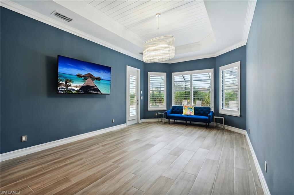 8239 Potomac Lane Naples, FL 34104 - Photo 12 of 47 a view of a room with furniture large windows and wooden floor