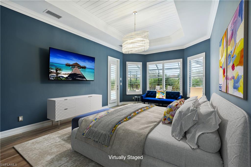8239 Potomac Lane Naples, FL 34104 - Photo 13 of 47 a spacious bedroom with a bed and a large window