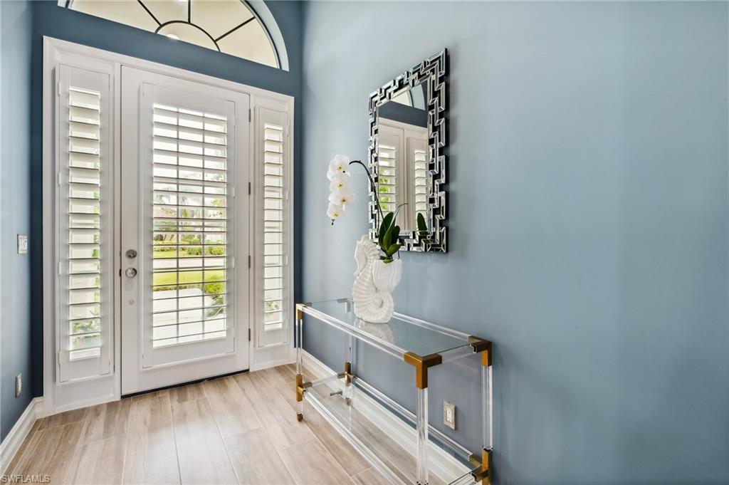 8239 Potomac Lane Naples, FL 34104 - Photo 15 of 47 a view of an entryway with wooden floor