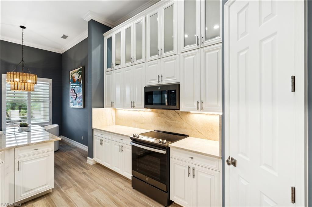 8239 Potomac Lane Naples, FL 34104 - Photo 17 of 47 a kitchen with stainless steel appliances granite countertop a stove and a refrigerator