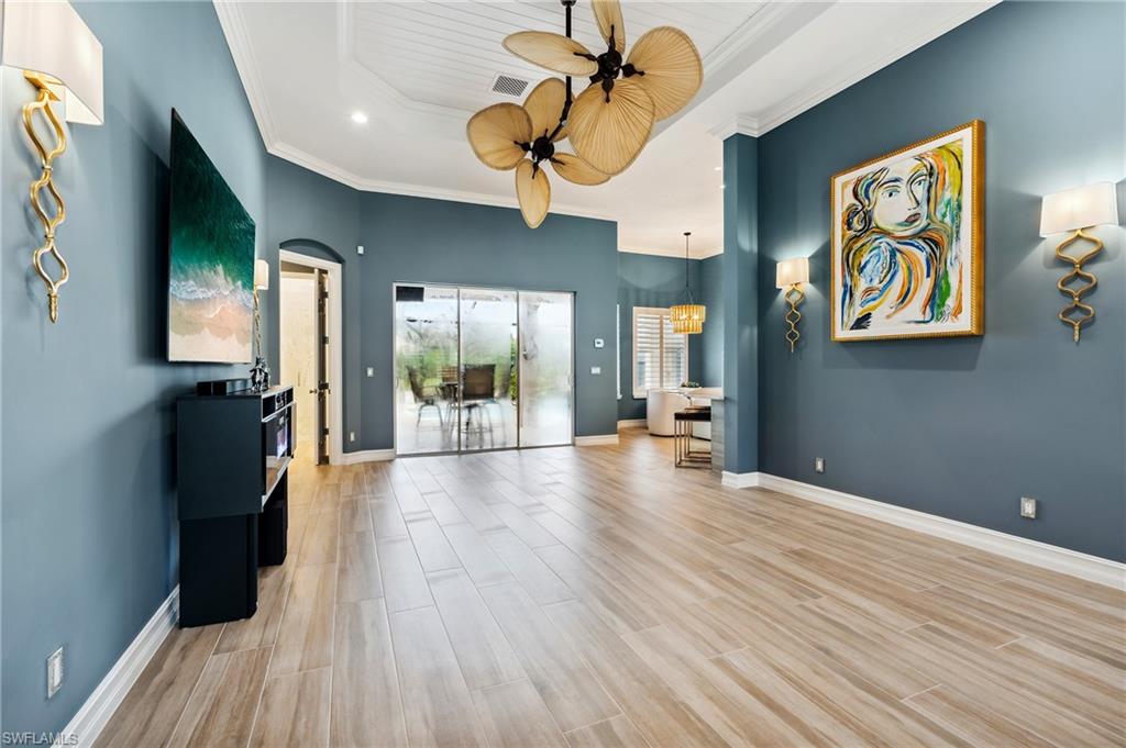 8239 Potomac Lane Naples, FL 34104 - Photo 23 of 47 a view of an empty room with wooden floor and a window