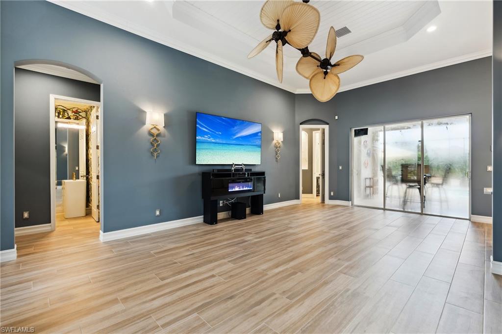 8239 Potomac Lane Naples, FL 34104 - Photo 24 of 47 a view of an empty room with glass door and wooden floor