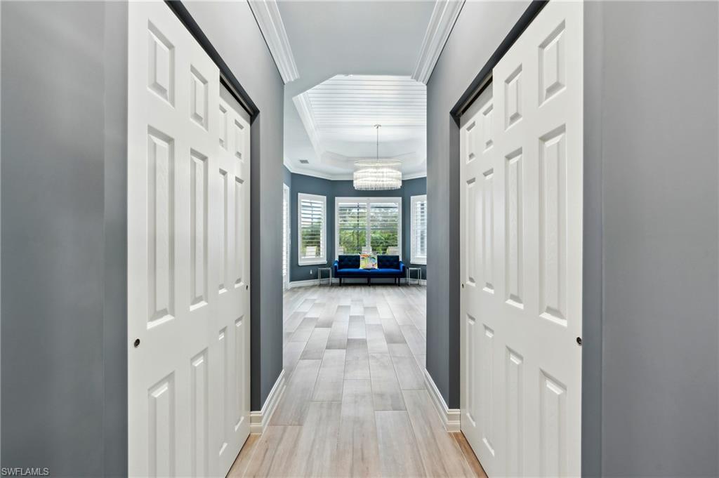 8239 Potomac Lane Naples, FL 34104 - Photo 27 of 47 a view of a hallway with wooden floor and staircase