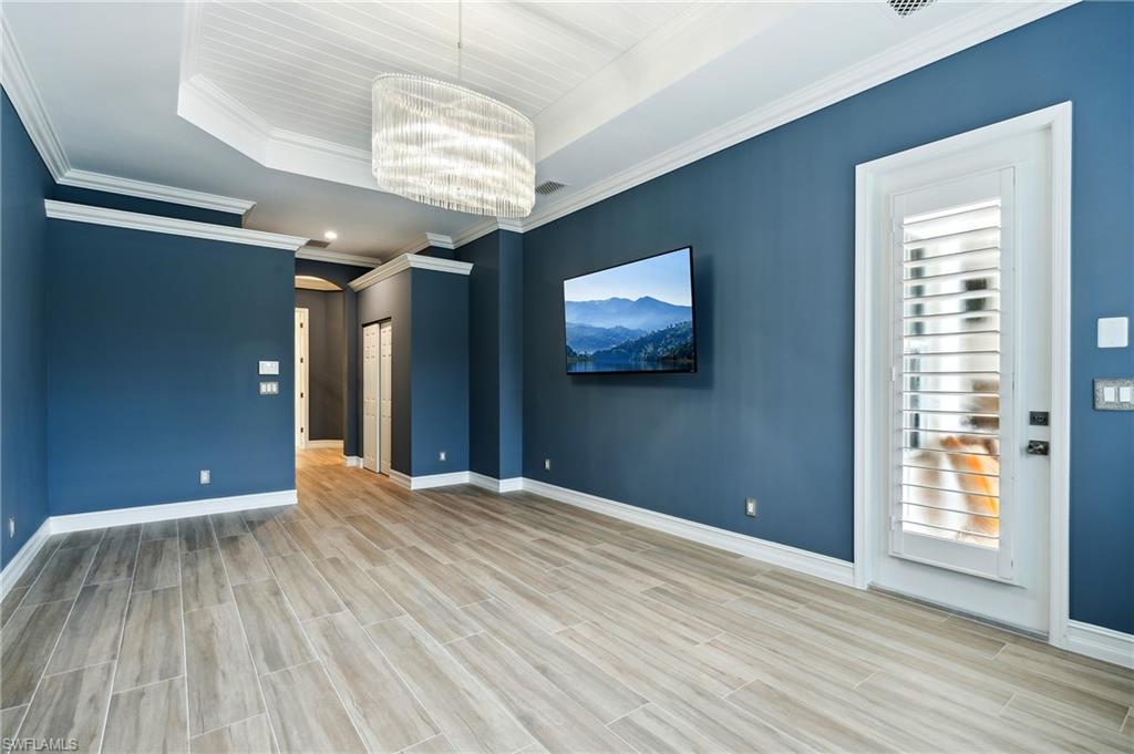 8239 Potomac Lane Naples, FL 34104 - Photo 29 of 47 a view of empty room with wooden floor and fan