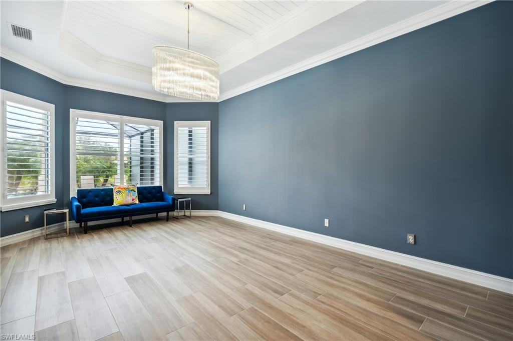 8239 Potomac Lane Naples, FL 34104 - Photo 30 of 47 an empty room with wooden floor and windows