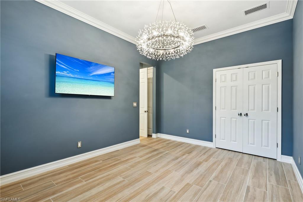 8239 Potomac Lane Naples, FL 34104 - Photo 33 of 47 a view of a hallway with a chandelier