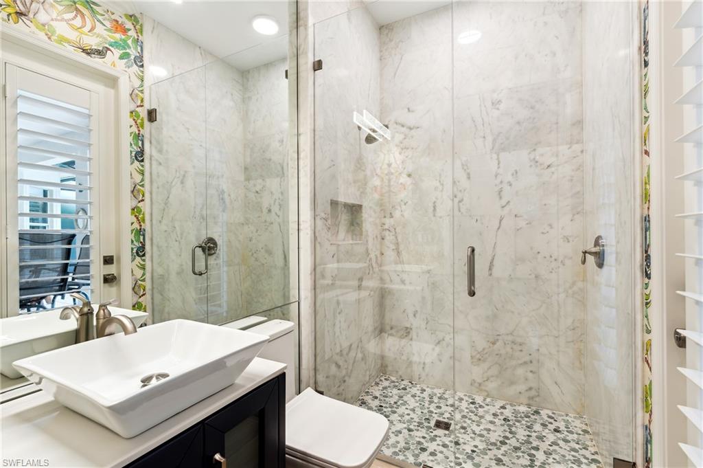 8239 Potomac Lane Naples, FL 34104 - Photo 34 of 47 a bathroom with a sink a toilet and shower