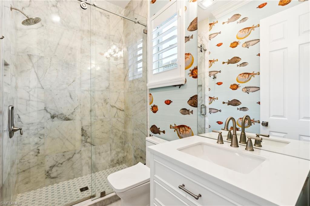 8239 Potomac Lane Naples, FL 34104 - Photo 37 of 47 a bathroom with a sink a toilet and shower curtain