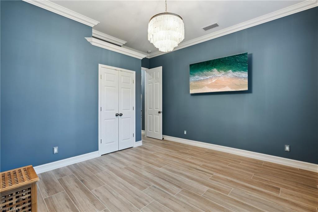 8239 Potomac Lane Naples, FL 34104 - Photo 39 of 47 a view of empty room with wooden floor