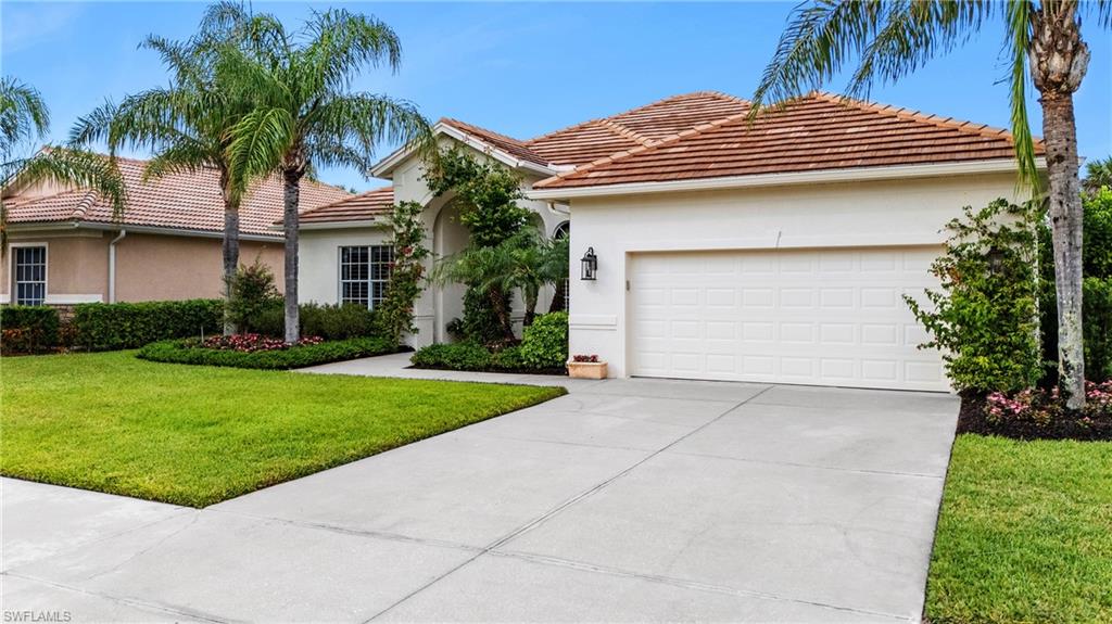 8239 Potomac Lane Naples, FL 34104 - Photo 41 of 47 a view of a house with a yard plants and palm trees