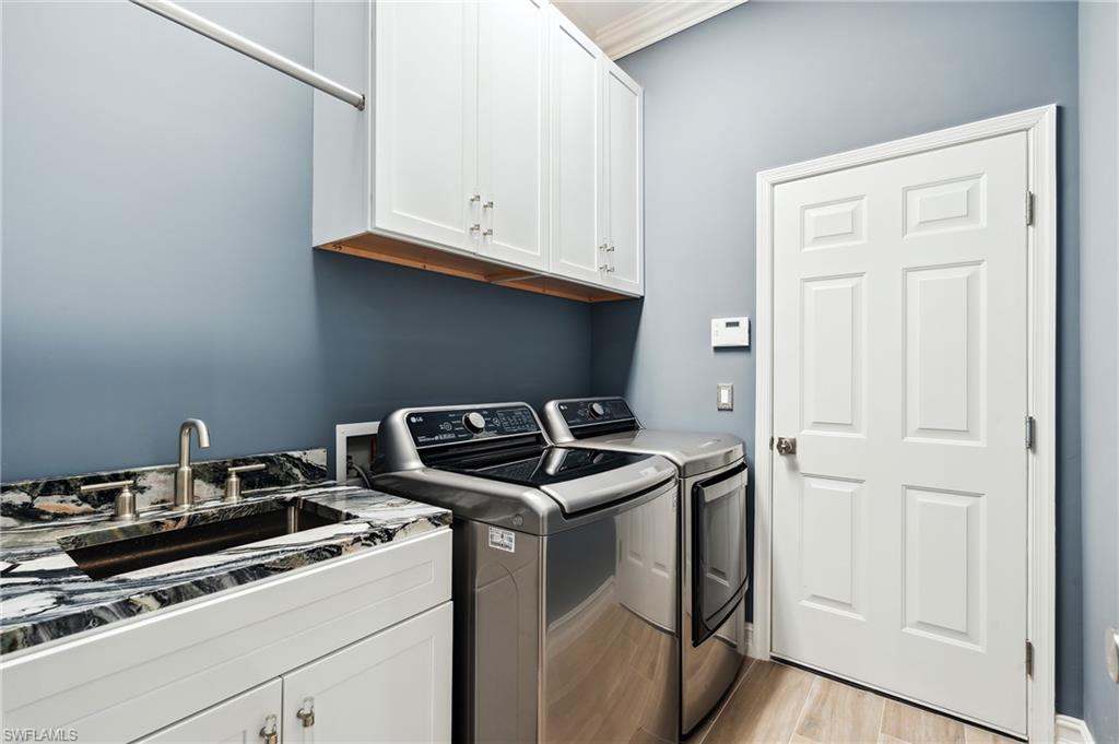 8239 Potomac Lane Naples, FL 34104 - Photo 43 of 47 a utility room with dryer and washer