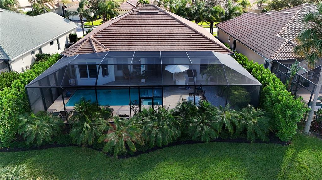 8239 Potomac Lane Naples, FL 34104 - Photo 44 of 47 a view of a house with a yard plants and large tree