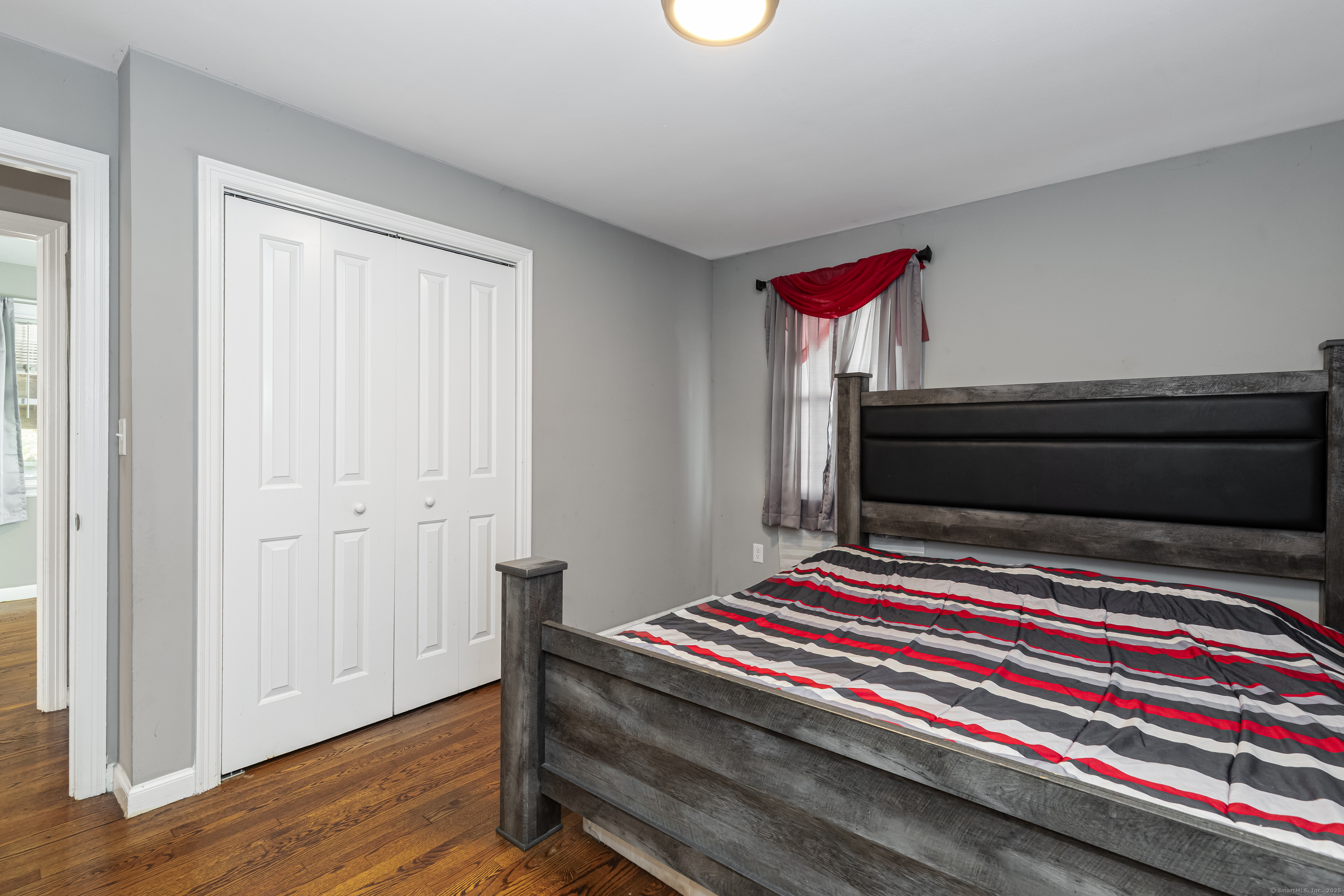 148 Central Avenue West Haven, CT 06516 - Photo 12 of 26 a bedroom with a bed and wooden floor