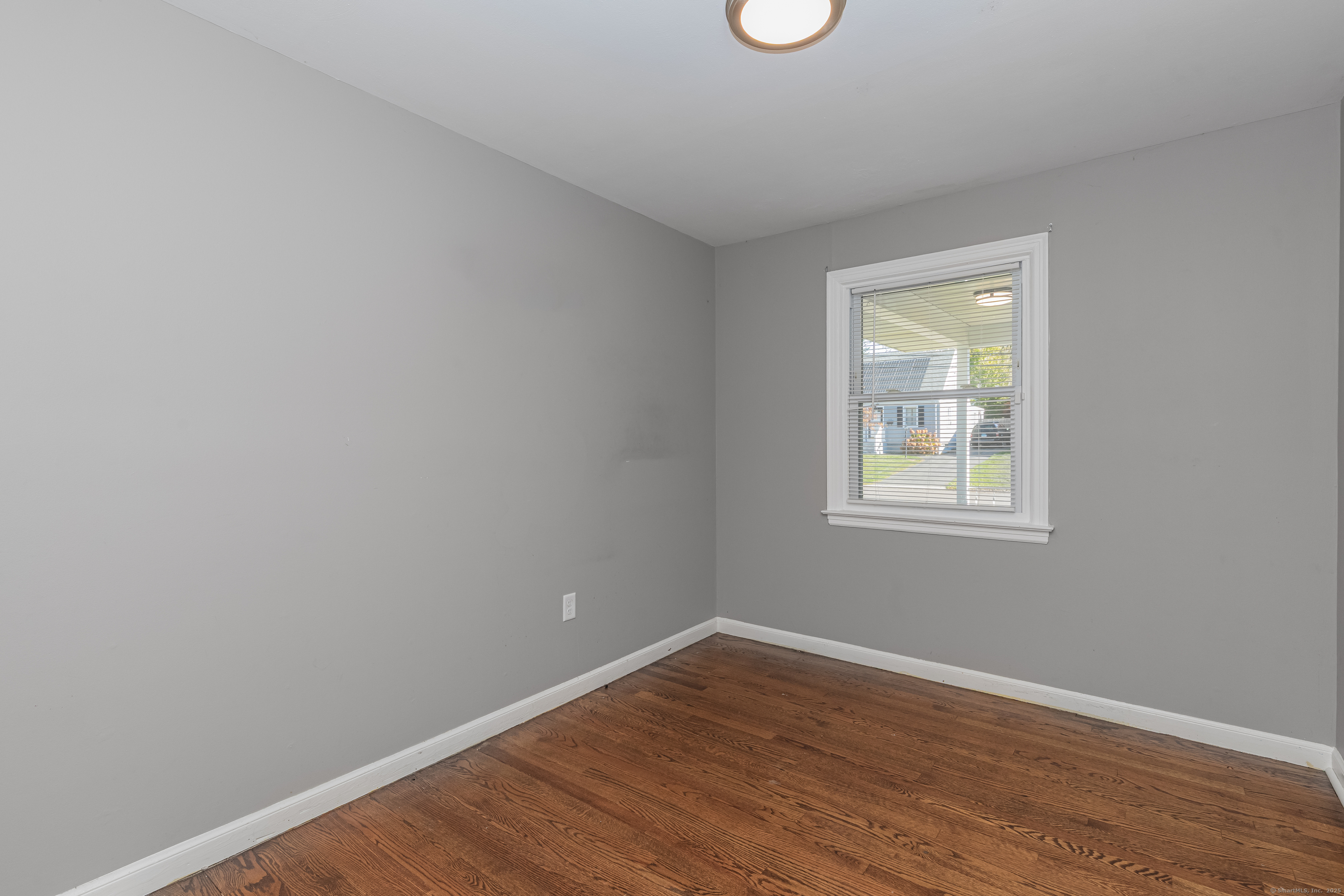 148 Central Avenue West Haven, CT 06516 - Photo 14 of 26 a view of an empty room with wooden floor and a window
