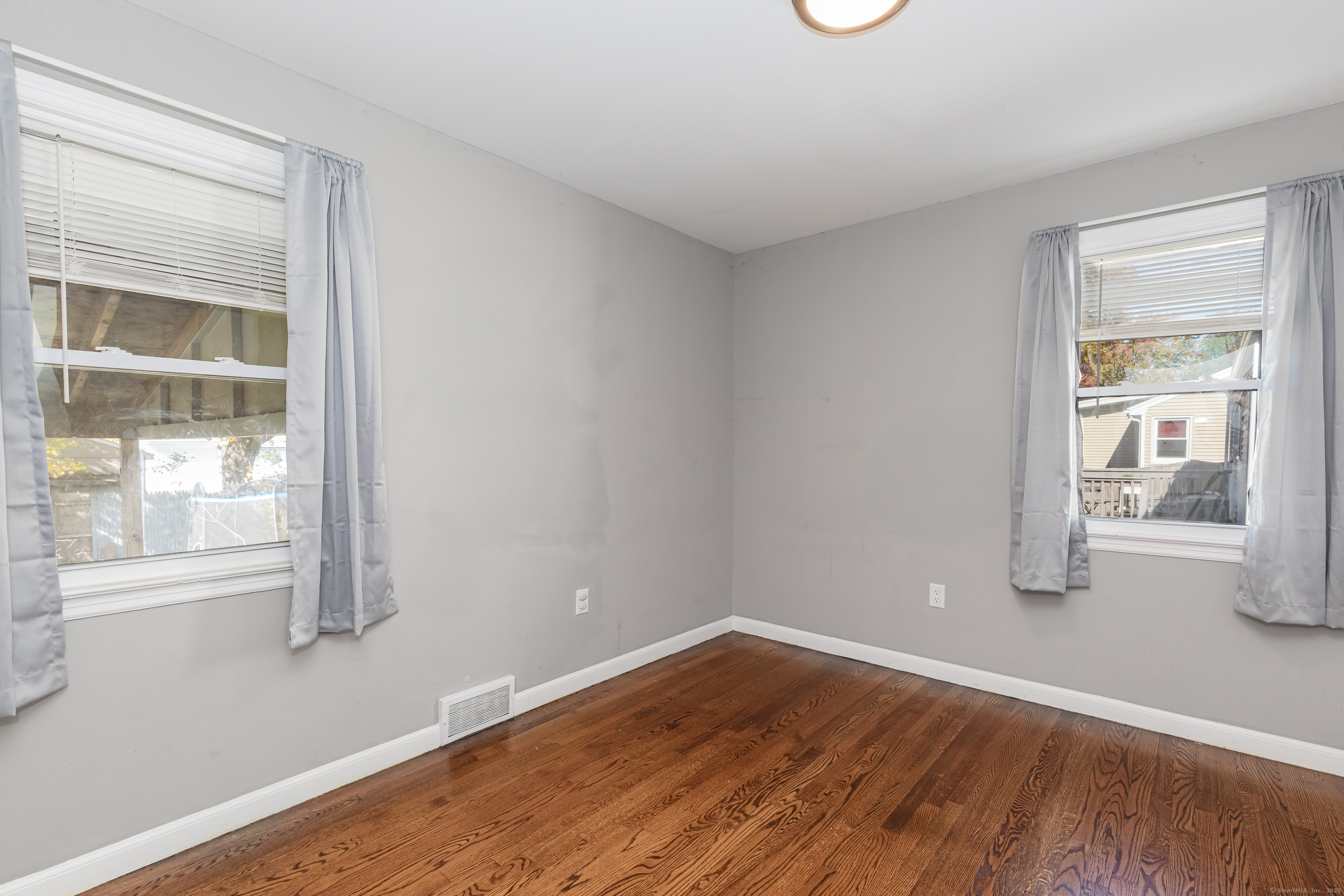 148 Central Avenue West Haven, CT 06516 - Photo 15 of 26 a view of empty room with wooden floor and fan