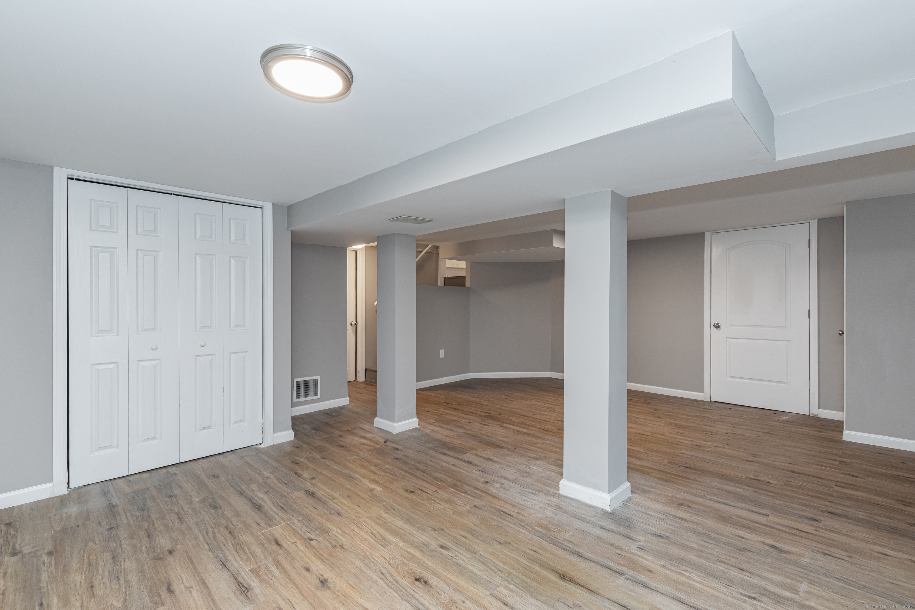 148 Central Avenue West Haven, CT 06516 - Photo 19 of 26 an empty room with wooden floor & closet area