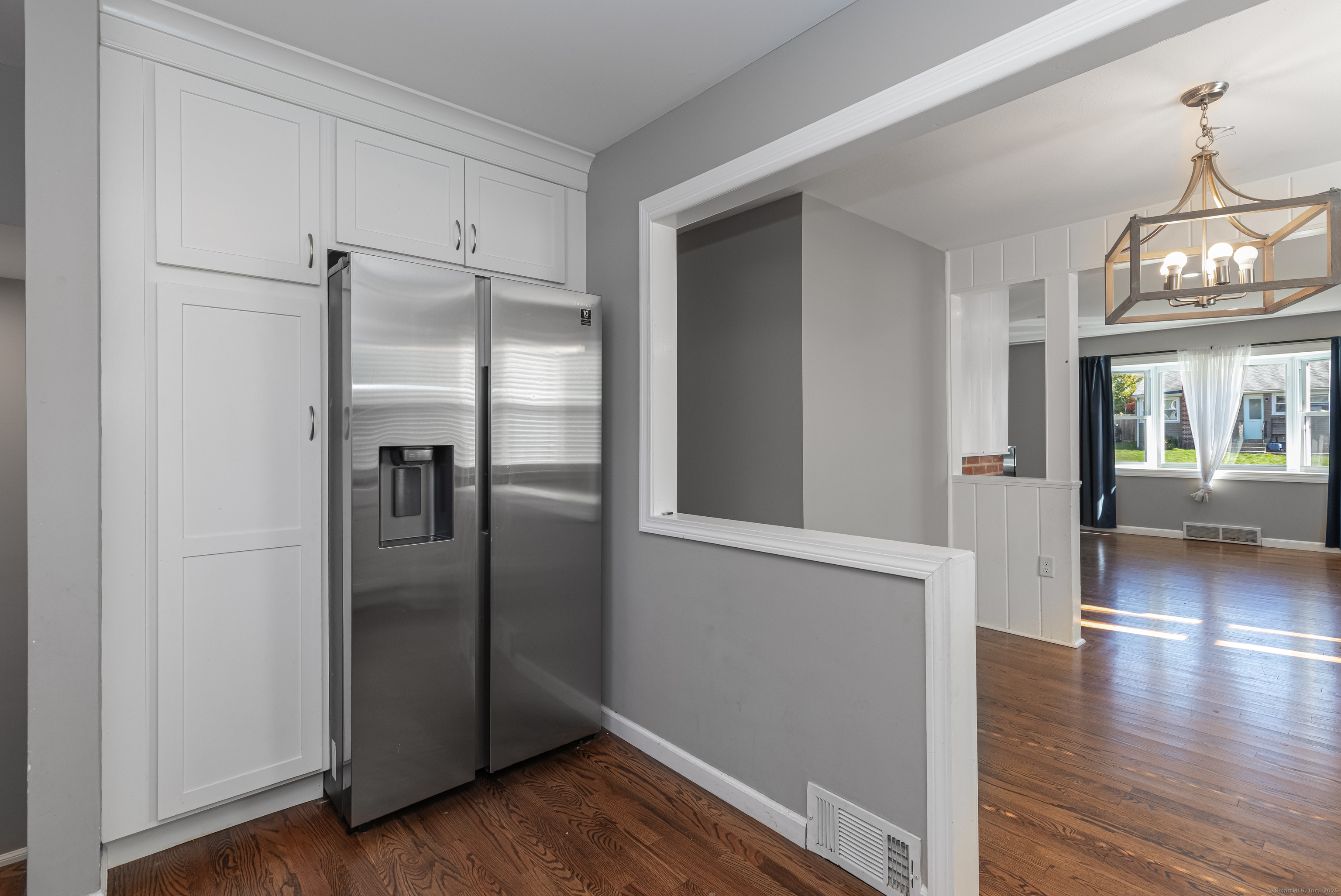 148 Central Avenue West Haven, CT 06516 - Photo 5 of 26 a view of a refrigerator in kitchen and wooden floor