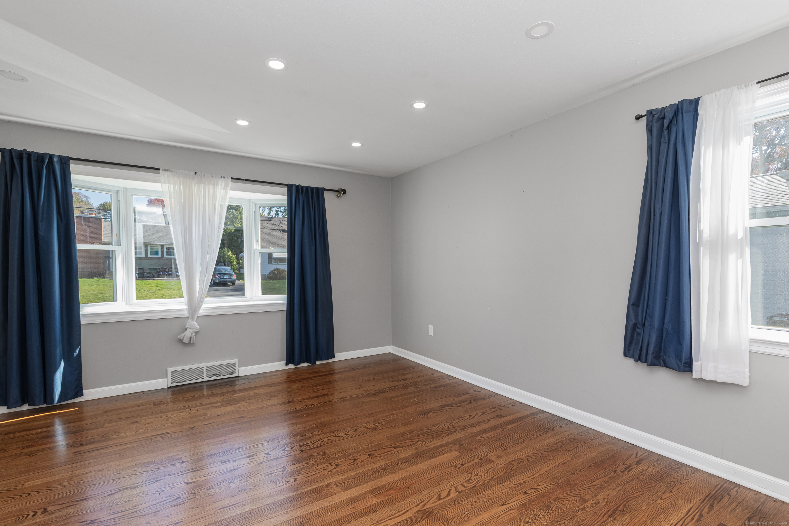 148 Central Avenue West Haven, CT 06516 - Photo 7 of 26 a view of an empty room with wooden floor and a window