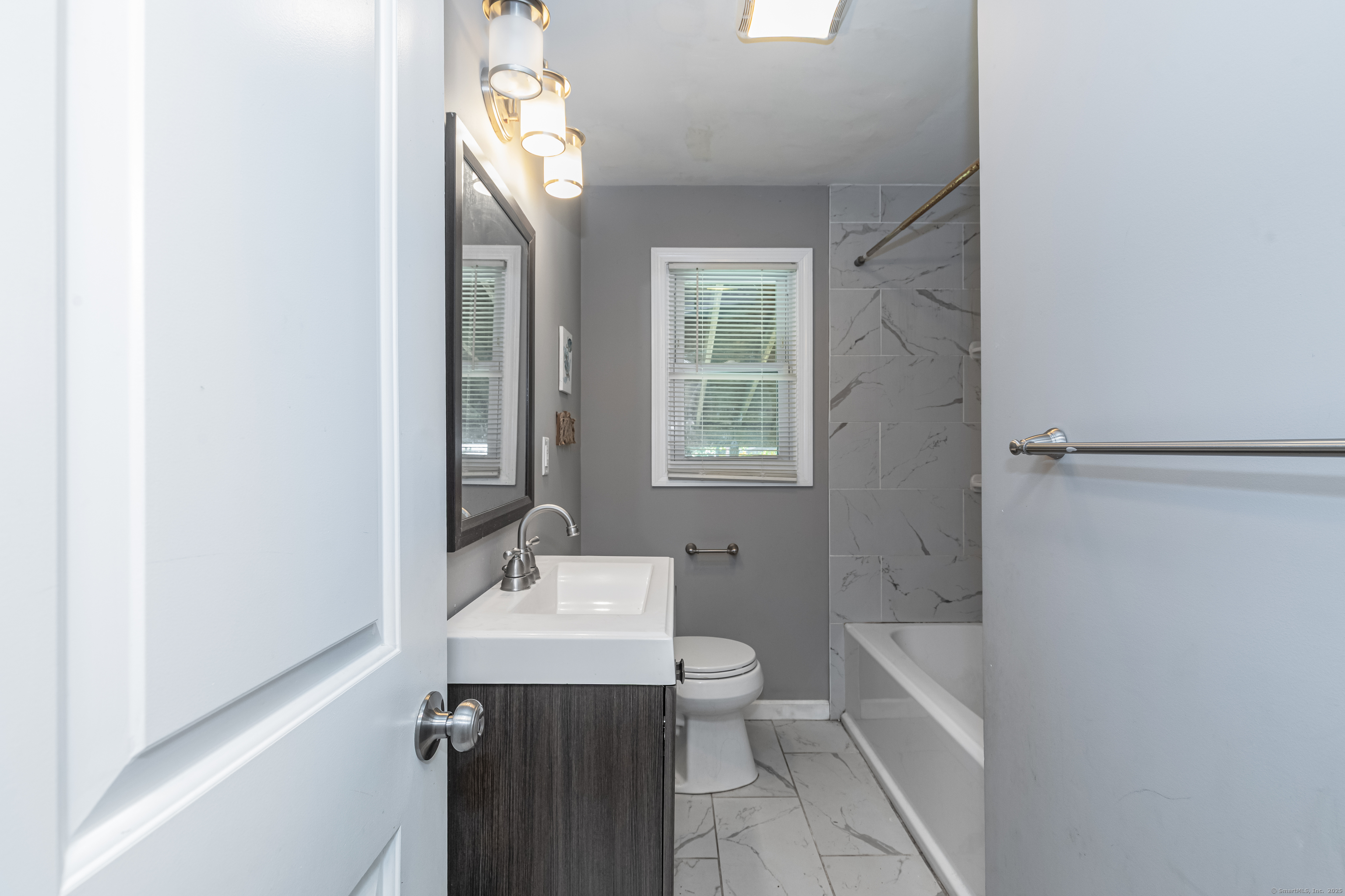 148 Central Avenue West Haven, CT 06516 - Photo 10 of 26 a bathroom with a sink a bathtub and a mirror