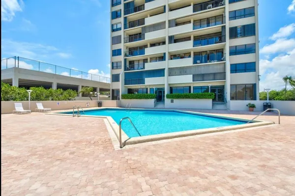 a view of yard with swimming pool and large tree