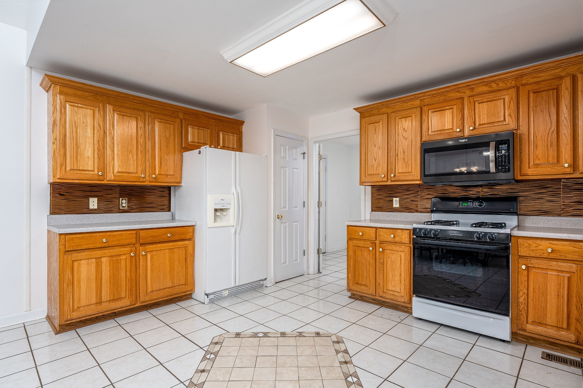 1346 Sam Johnson Road Columbia, TN 38401 - Photo 13 of 17 a kitchen with stainless steel appliances granite countertop a stove a sink and a microwave