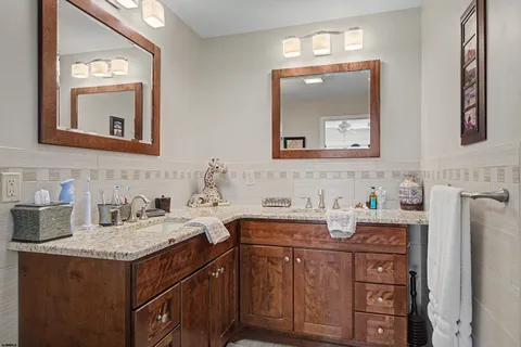 a bathroom with a sink vanity and mirror