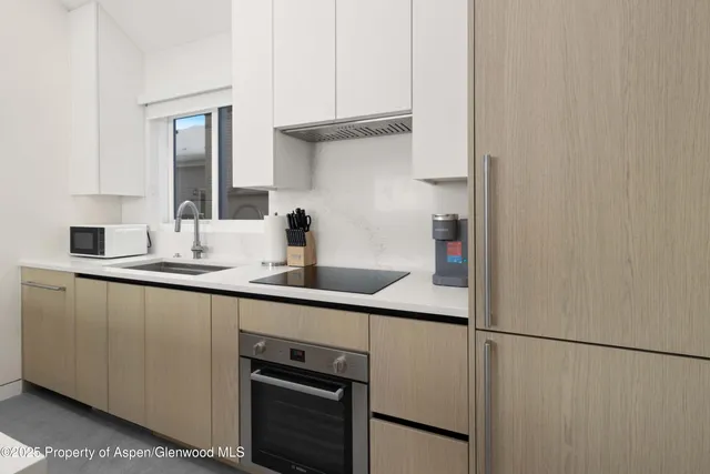 a kitchen with a sink and white cabinets