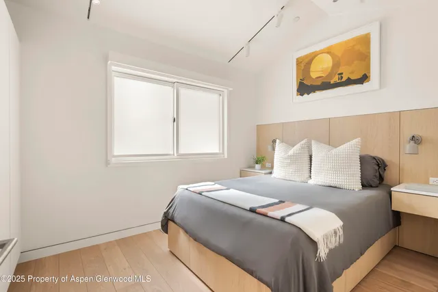 a bedroom with a bed and wall painting