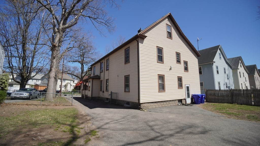54-56 Wayne Street Springfield, MA 01118 - Photo 7 of 8 a view of a white house with a yard