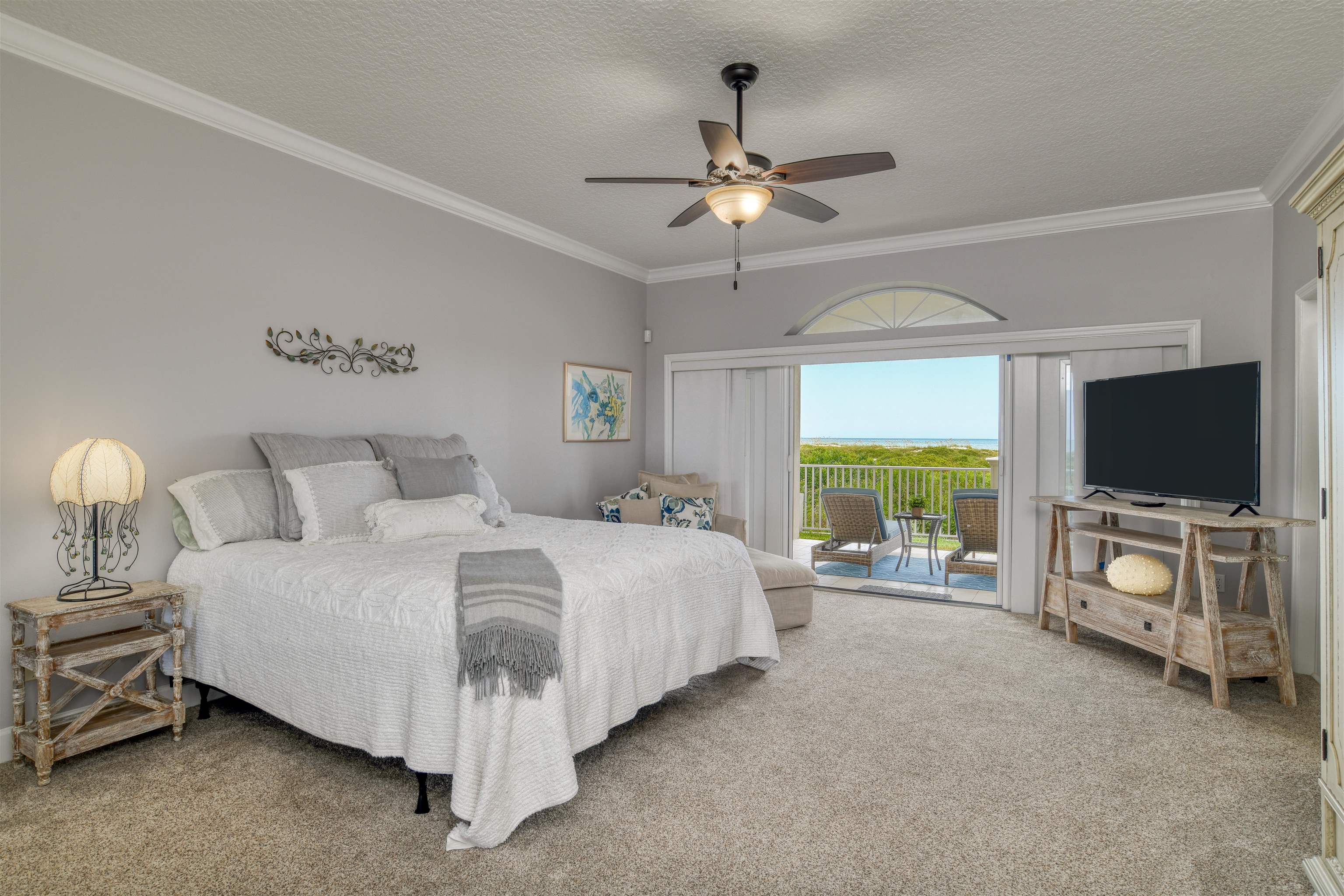 616 Mediterranean Way St. Augustine, FL 32080 - Photo 16 of 64 a spacious bedroom with a bed and a flat screen tv