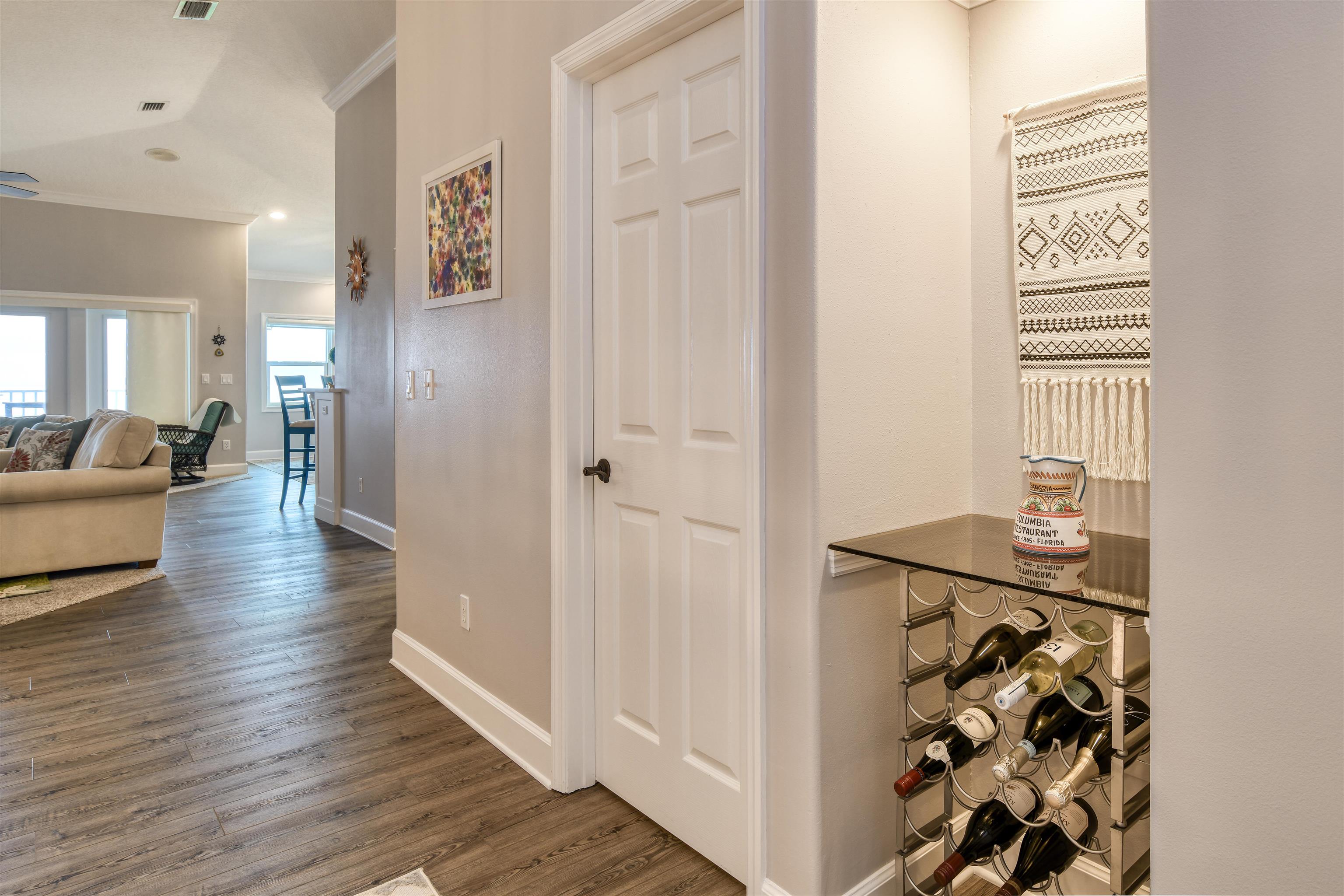 616 Mediterranean Way St. Augustine, FL 32080 - Photo 29 of 64 a view of a hallway with wooden floor and a livingroom with furniture