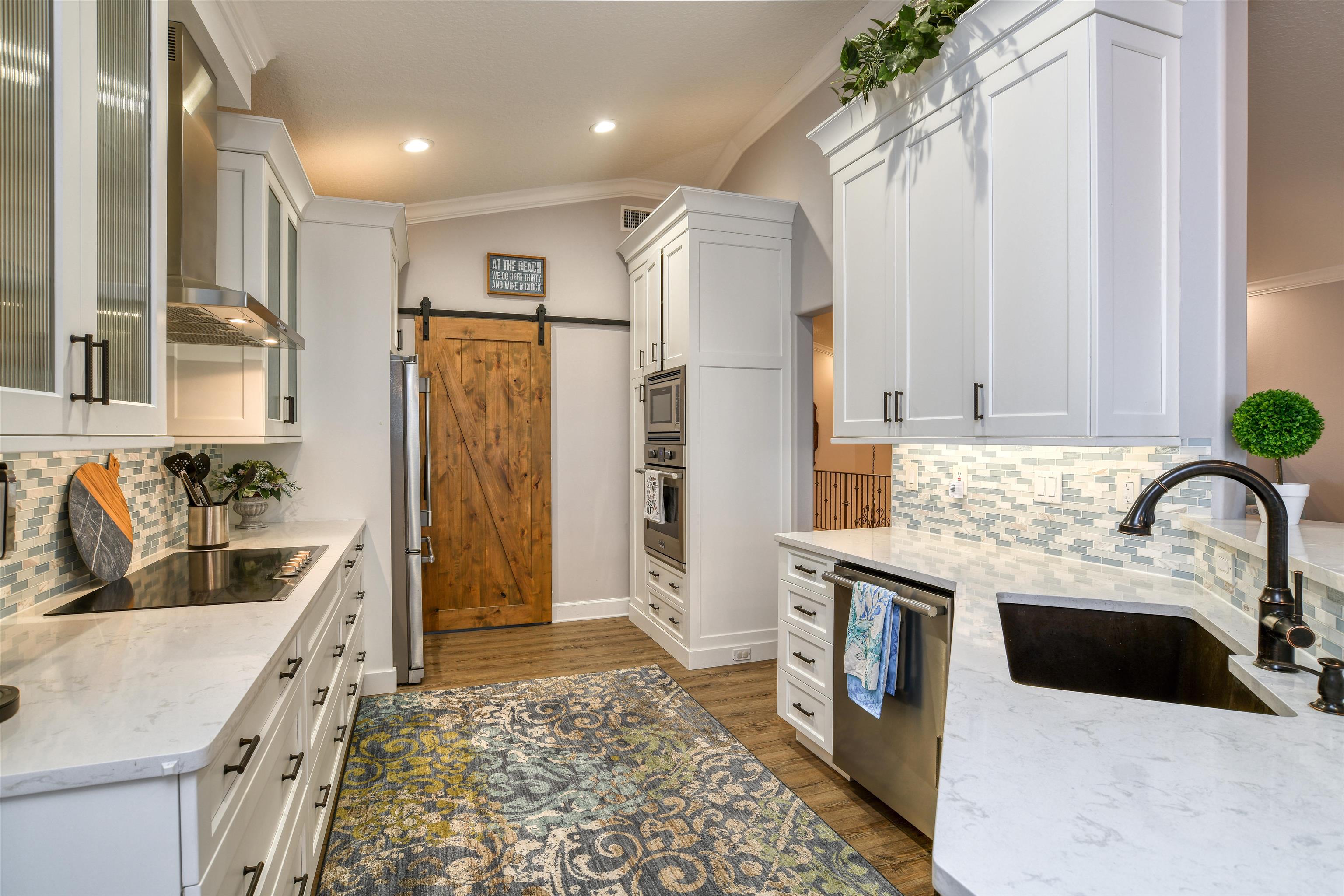 616 Mediterranean Way St. Augustine, FL 32080 - Photo 45 of 64 a kitchen with stainless steel appliances granite countertop a sink stove and refrigerator