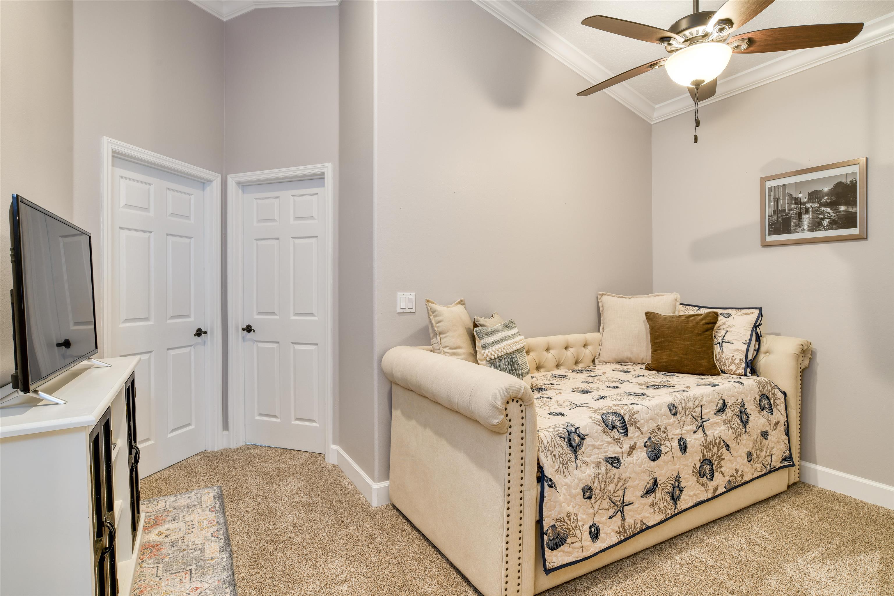 616 Mediterranean Way St. Augustine, FL 32080 - Photo 49 of 64 a bedroom with a bed and a flat tv screen on the dresser