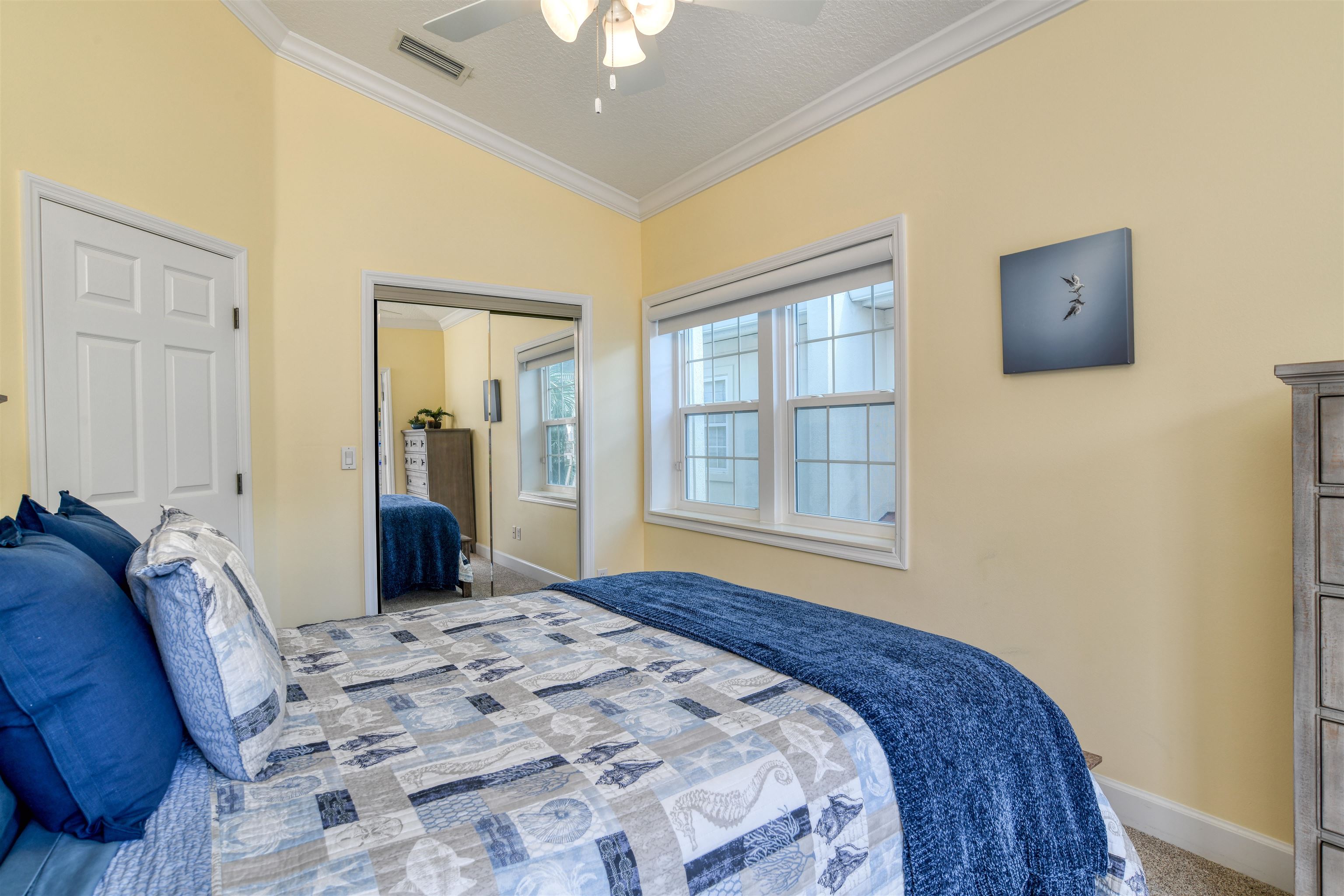 616 Mediterranean Way St. Augustine, FL 32080 - Photo 54 of 64 a bedroom with a bed and a window