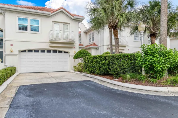 a front view of a house with a yard and a garage