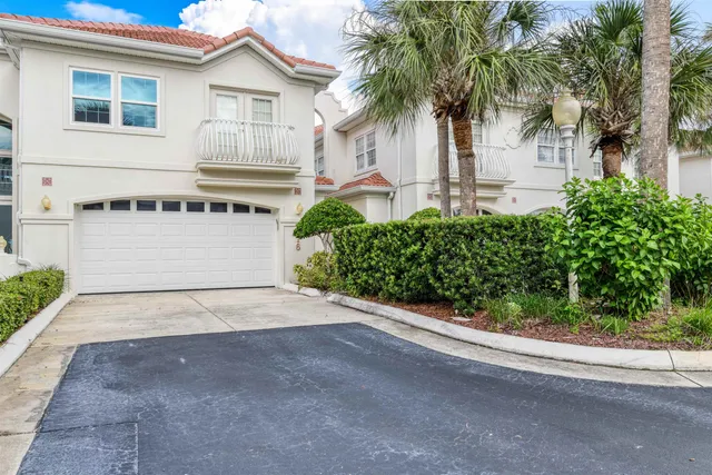 a front view of a house with a yard and a garage