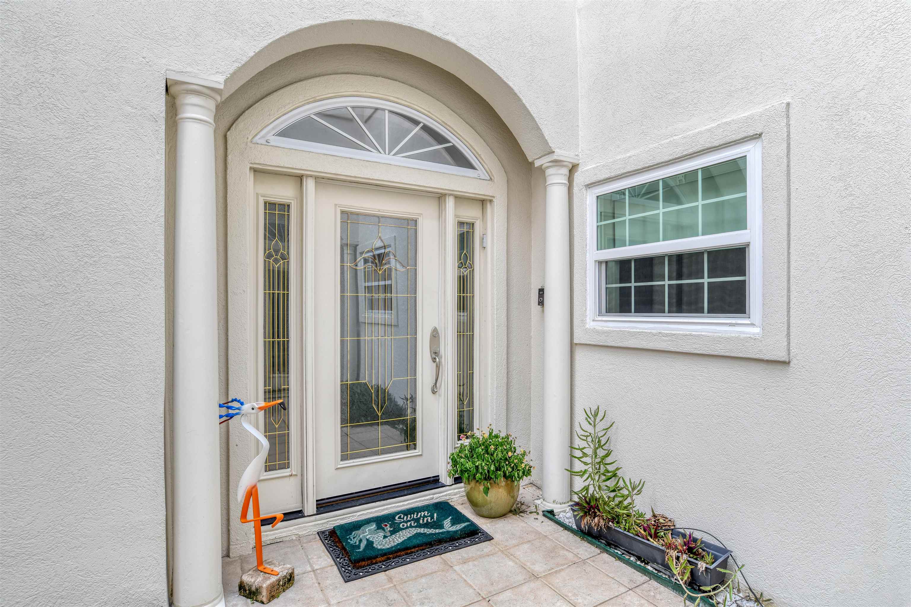616 Mediterranean Way St. Augustine, FL 32080 - Photo 9 of 64 a front view of a house with a garden