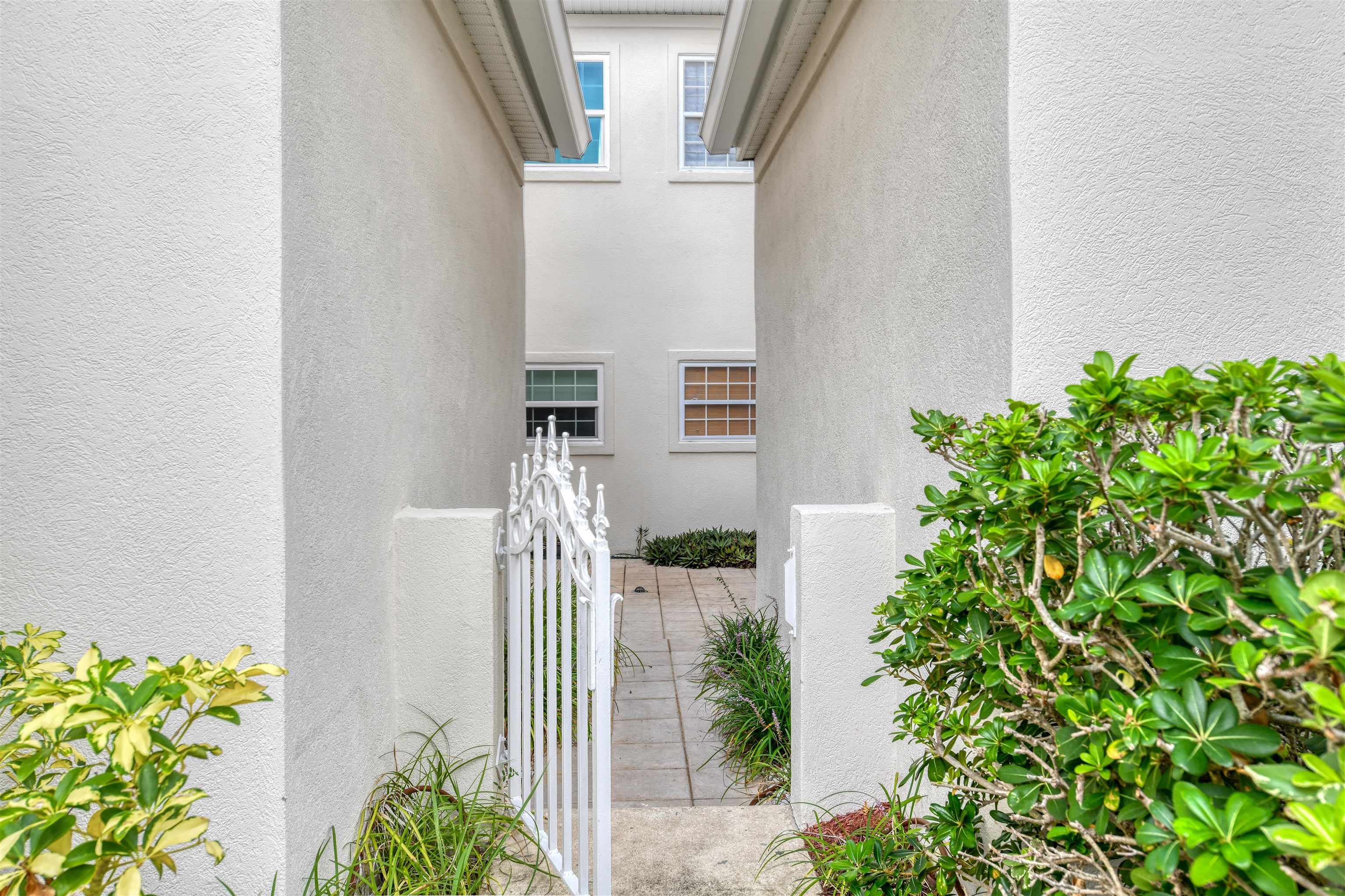 616 Mediterranean Way St. Augustine, FL 32080 - Photo 10 of 64 a front view of a house with a flower garden