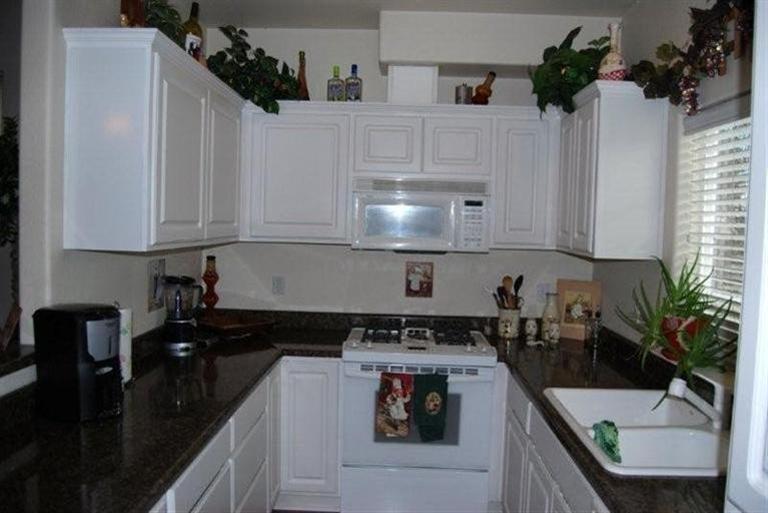 660 Shadow Way Central Point, OR 97502 - Photo 6 of 18 a kitchen with granite countertop a sink a stove and cabinets