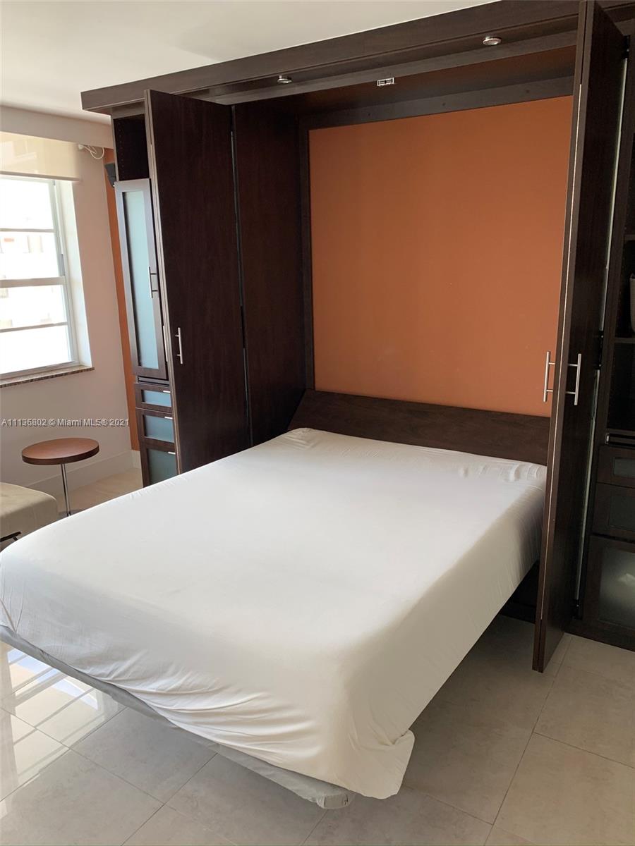 100 Lincoln Road, Unit 928 Miami Beach, FL 33139 - Photo 12 of 21 a bed sitting in a bedroom next to a window