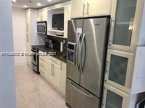 100 Lincoln Road, Unit 928 Miami Beach, FL 33139 - Photo 2 of 21 a kitchen with stainless steel appliances a refrigerator sink and microwave