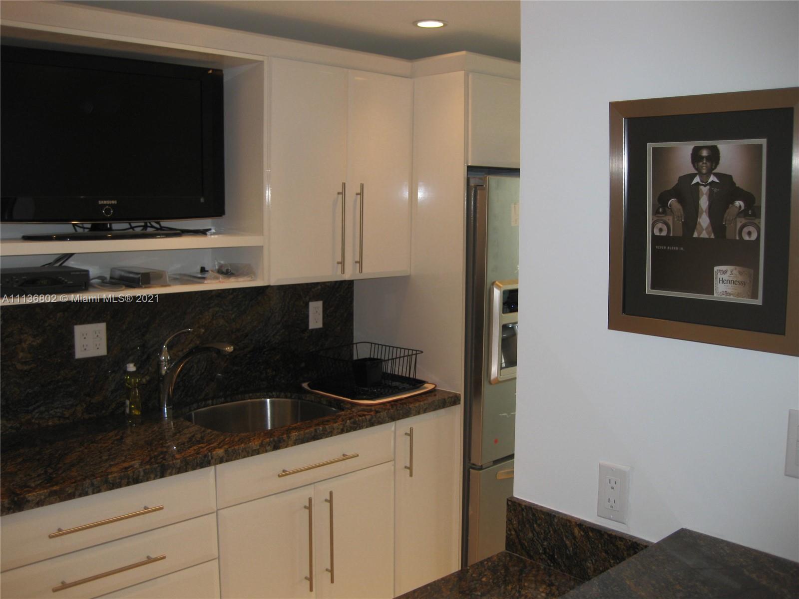 100 Lincoln Road, Unit 928 Miami Beach, FL 33139 - Photo 3 of 21 a kitchen with a sink and cabinets