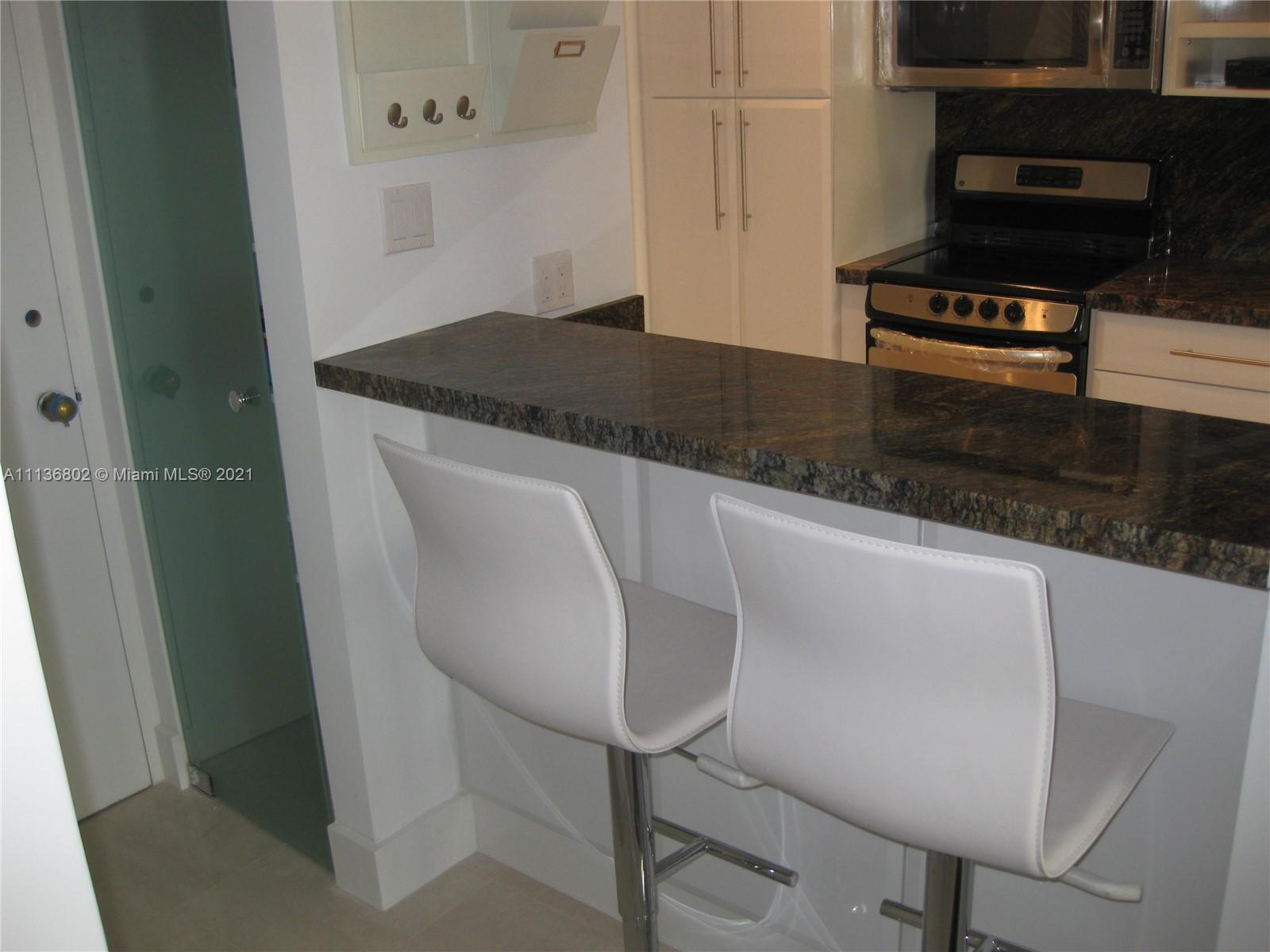 100 Lincoln Road, Unit 928 Miami Beach, FL 33139 - Photo 4 of 21 a kitchen with a sink and a stove