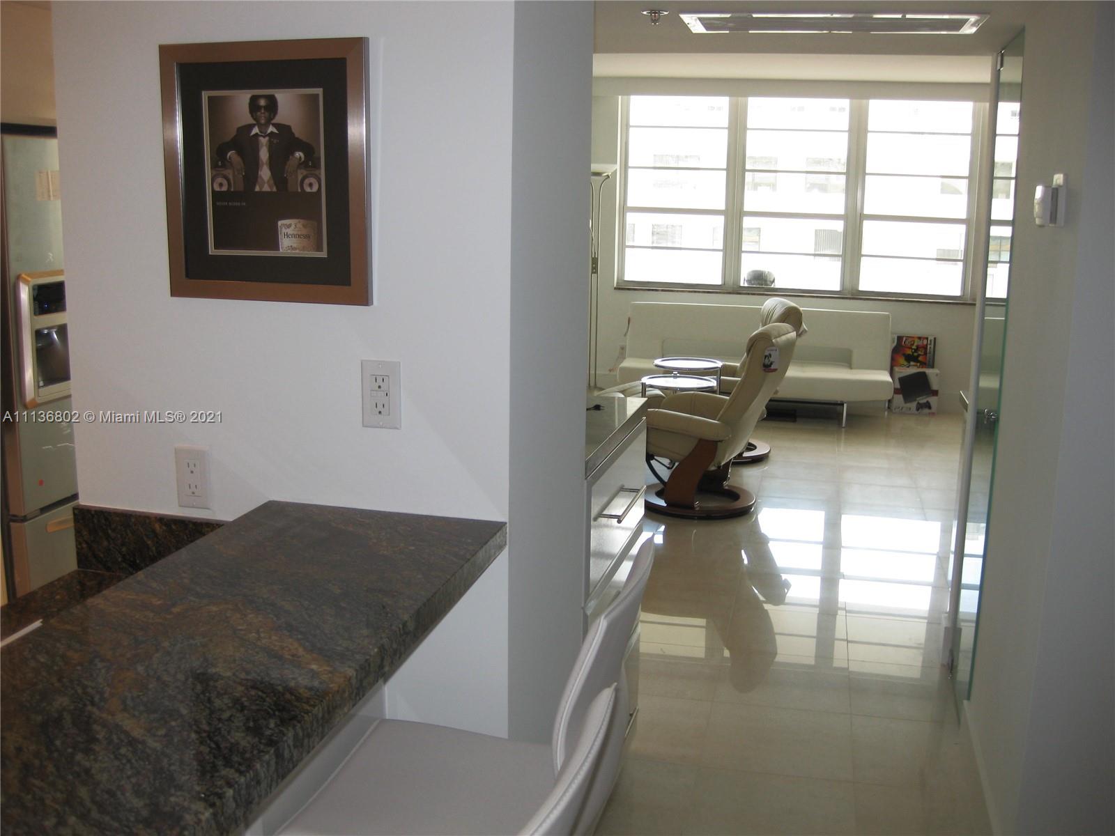 100 Lincoln Road, Unit 928 Miami Beach, FL 33139 - Photo 5 of 21 a living room with furniture and a chandelier