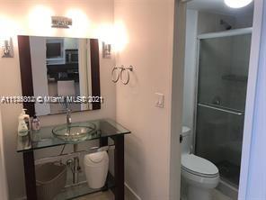 100 Lincoln Road, Unit 928 Miami Beach, FL 33139 - Photo 7 of 21 a bathroom with a granite countertop sink toilet and shower