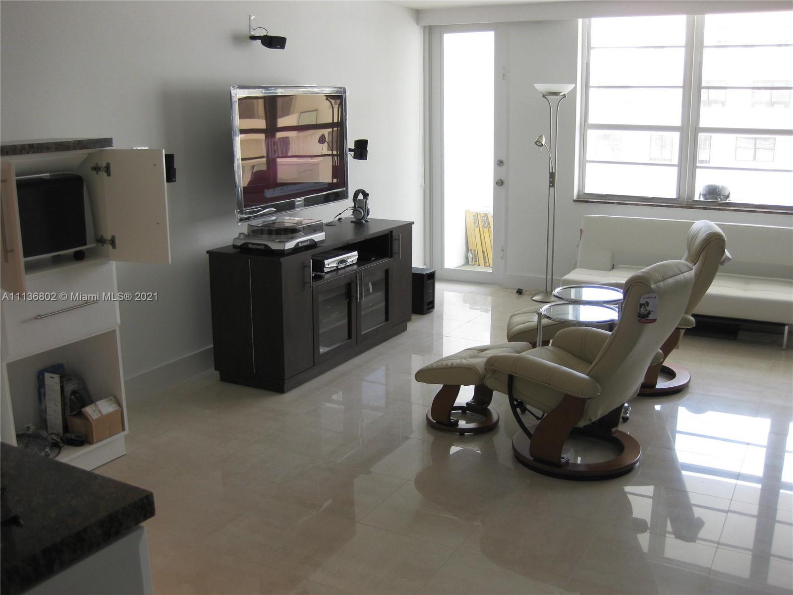 100 Lincoln Road, Unit 928 Miami Beach, FL 33139 - Photo 9 of 21 a living room with furniture and a flat screen tv